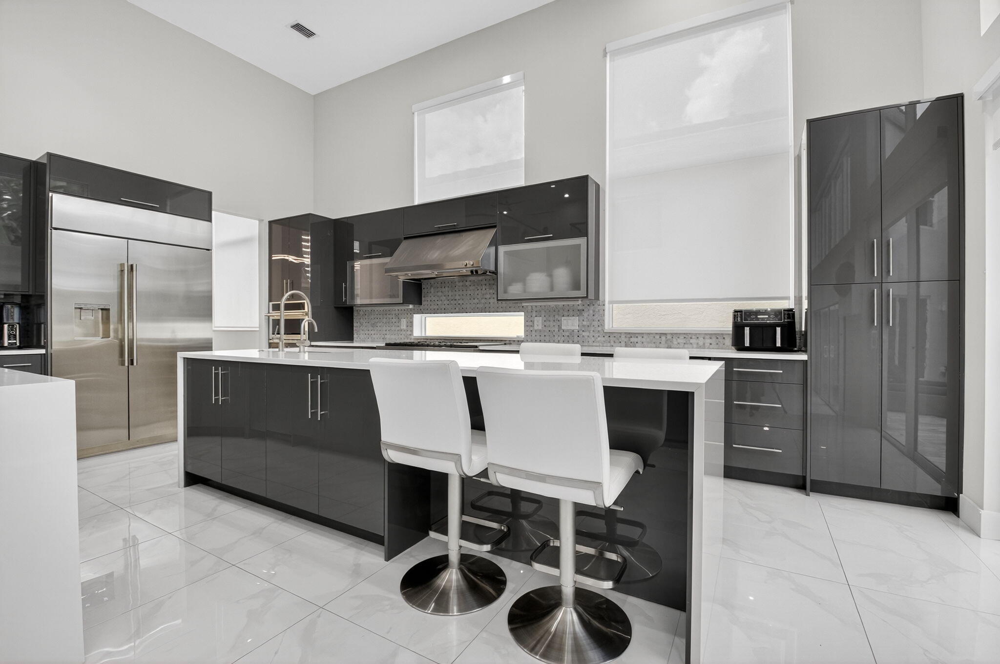 6529 Somerset Circle Boca Raton, FL 33496 - Photo 16 of 75 a kitchen with stainless steel appliances a sink a stove a refrigerator and cabinets