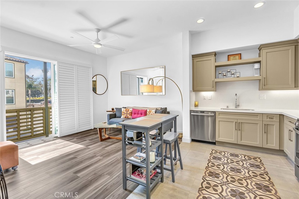 1632 Doheny Way Dana Point, CA 92629 - Photo 11 of 33 a view of a kitchen with stainless steel appliances granite countertop a stove a sink dishwasher and a dining table with wooden floor