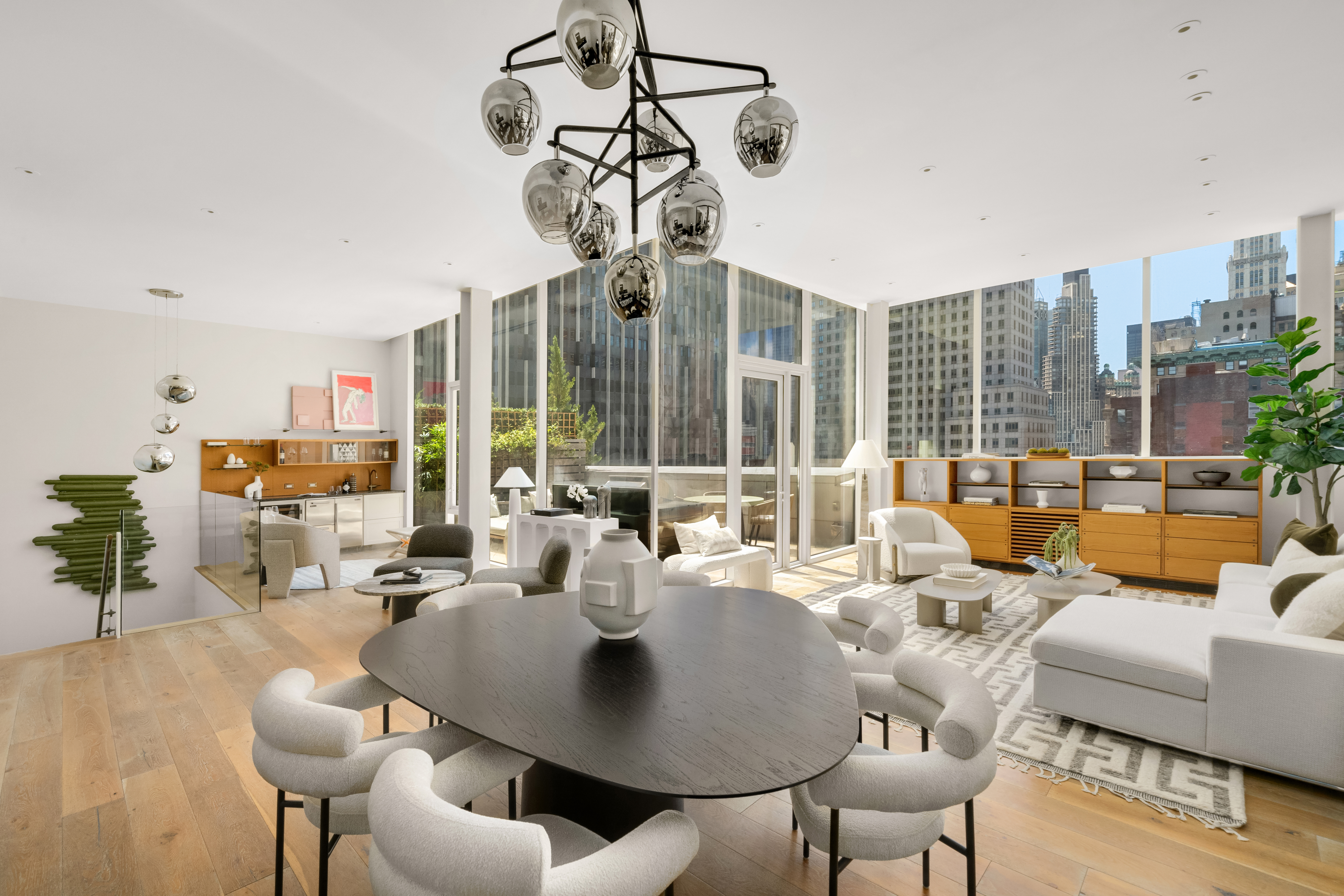 93 Worth Street, Unit PH5 Manhattan, NY 10013 - Photo 7 of 19 a living room with furniture a chandelier and a large window