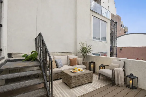 a outdoor living room with furniture and wooden floor