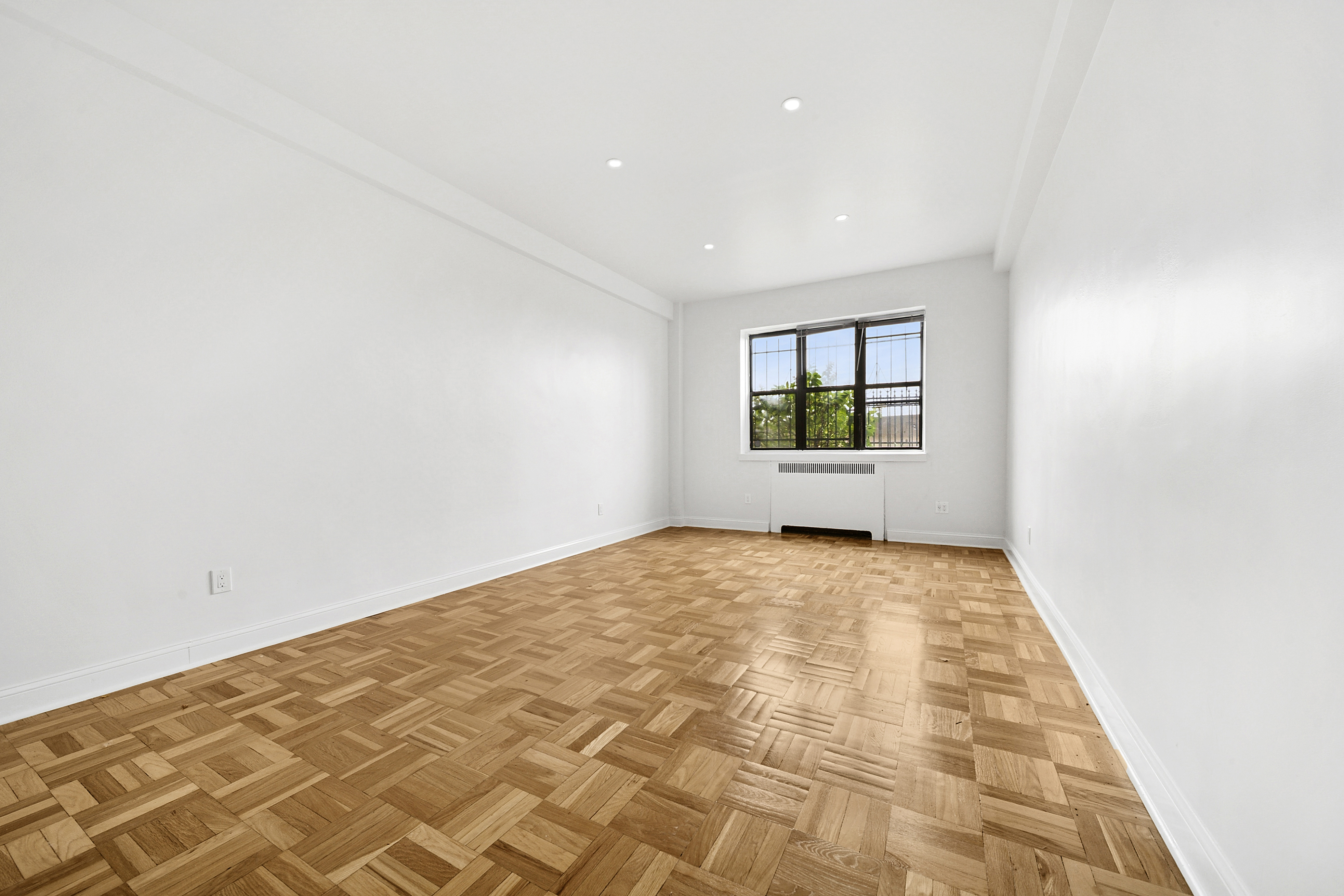 159-00 Riverside Drive West, Unit 1L70 Manhattan, NY 10032 - Photo 2 of 17 an empty room with windows