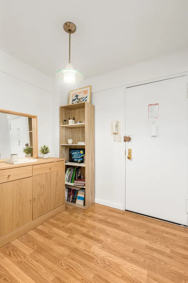 a view of a kitchen with refrigerator and window