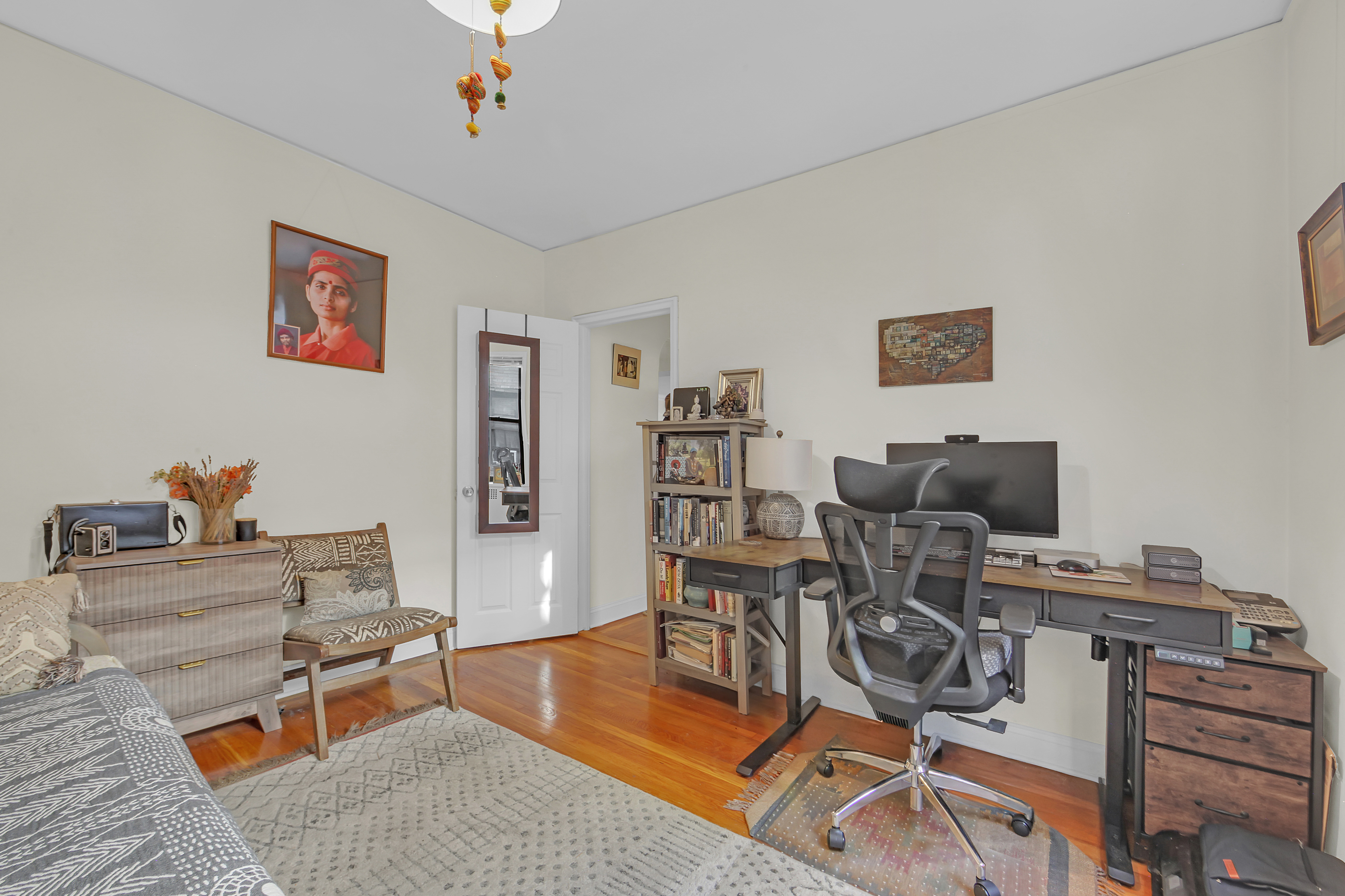 55 East 190th Street, Unit 59 Bronx, NY 10468 - Photo 9 of 14 a work room with furniture and wooden floor