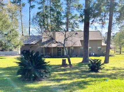 a view of a swimming pool with a patio and a yard