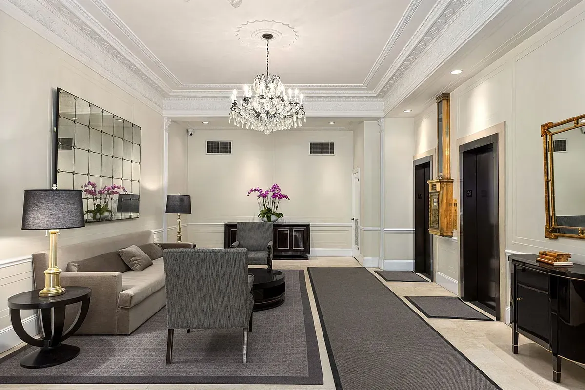 a view of a dining room with furniture and chandelier