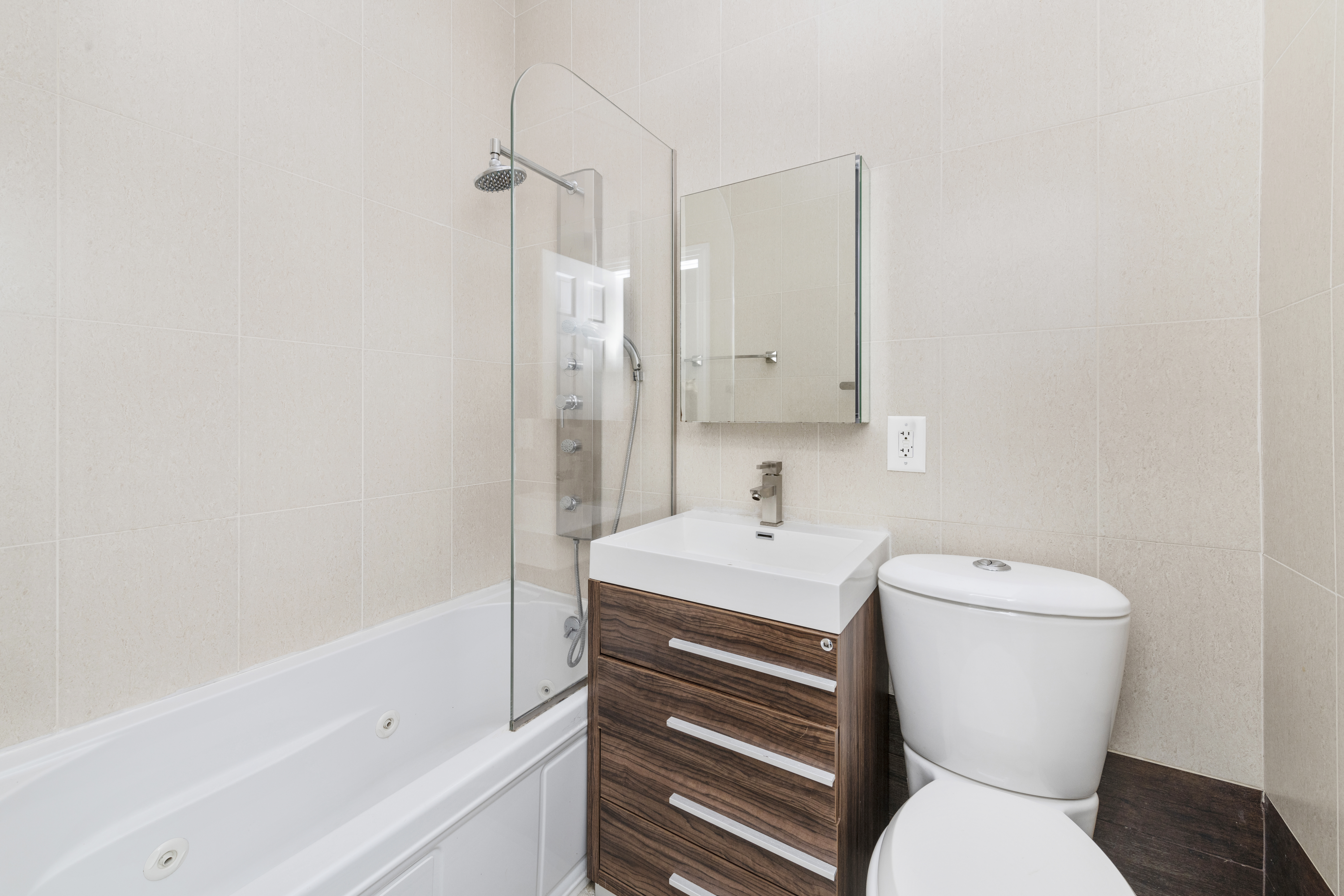 221 Troutman Street, Unit 4L Brooklyn, NY 11237 - Photo 7 of 11 a bathroom with a toilet sink and mirror