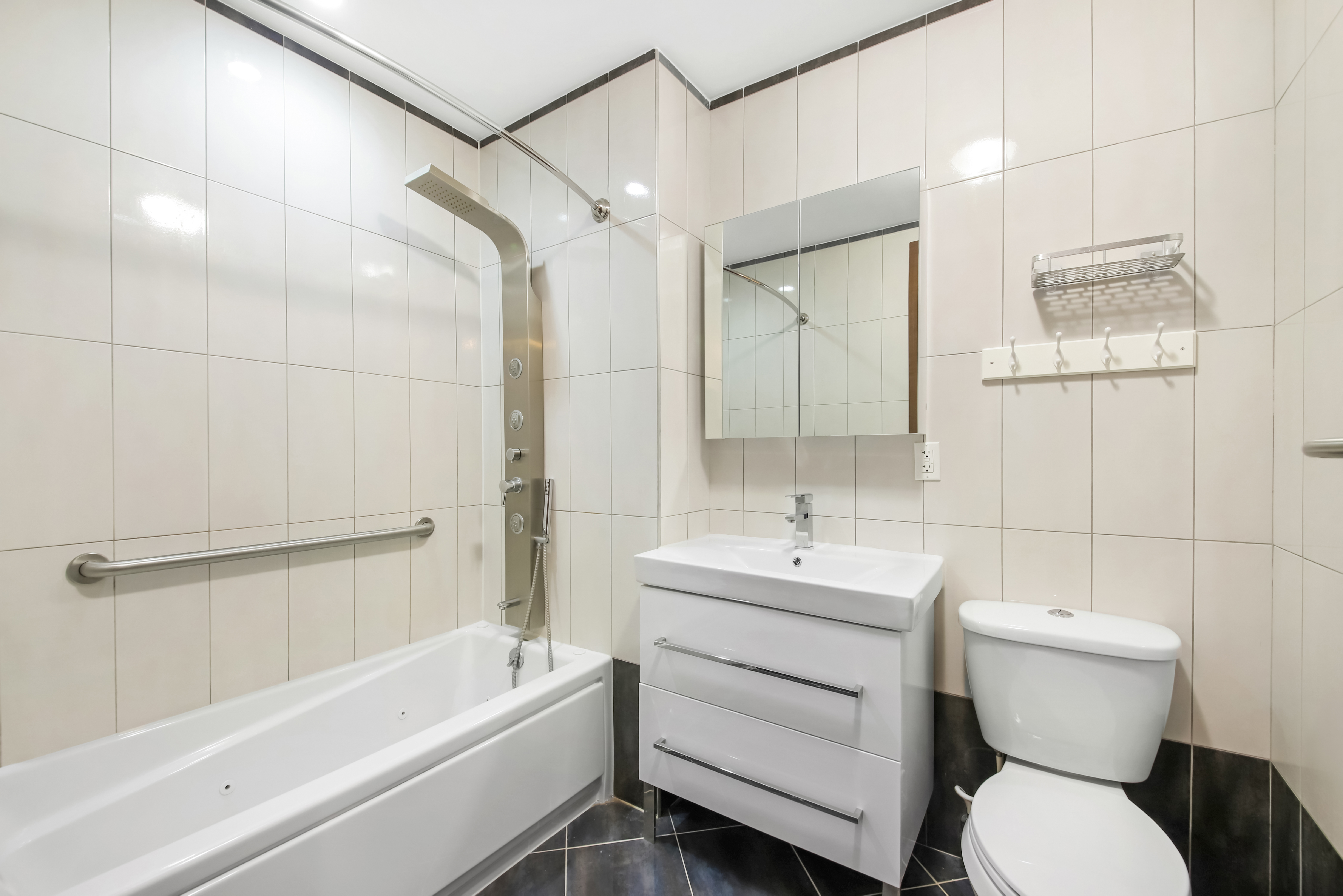 1756 Ocean Avenue, Unit 6D Brooklyn, NY 11230 - Photo 7 of 11 a bathroom with a sink toilet and shower