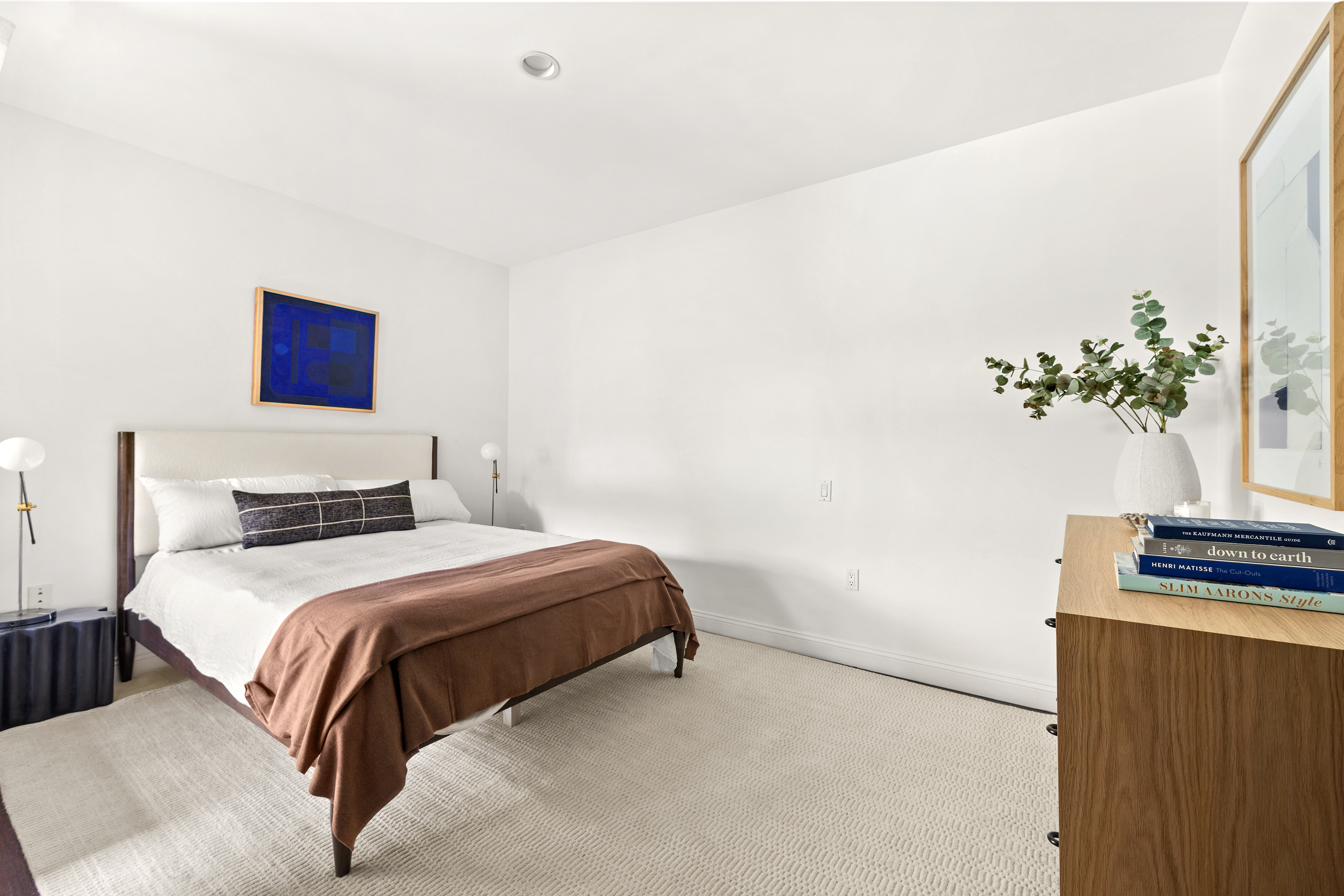 245 10th Avenue, Unit 2W Manhattan, NY 10001 - Photo 11 of 16 a bedroom with a bed and a potted plant