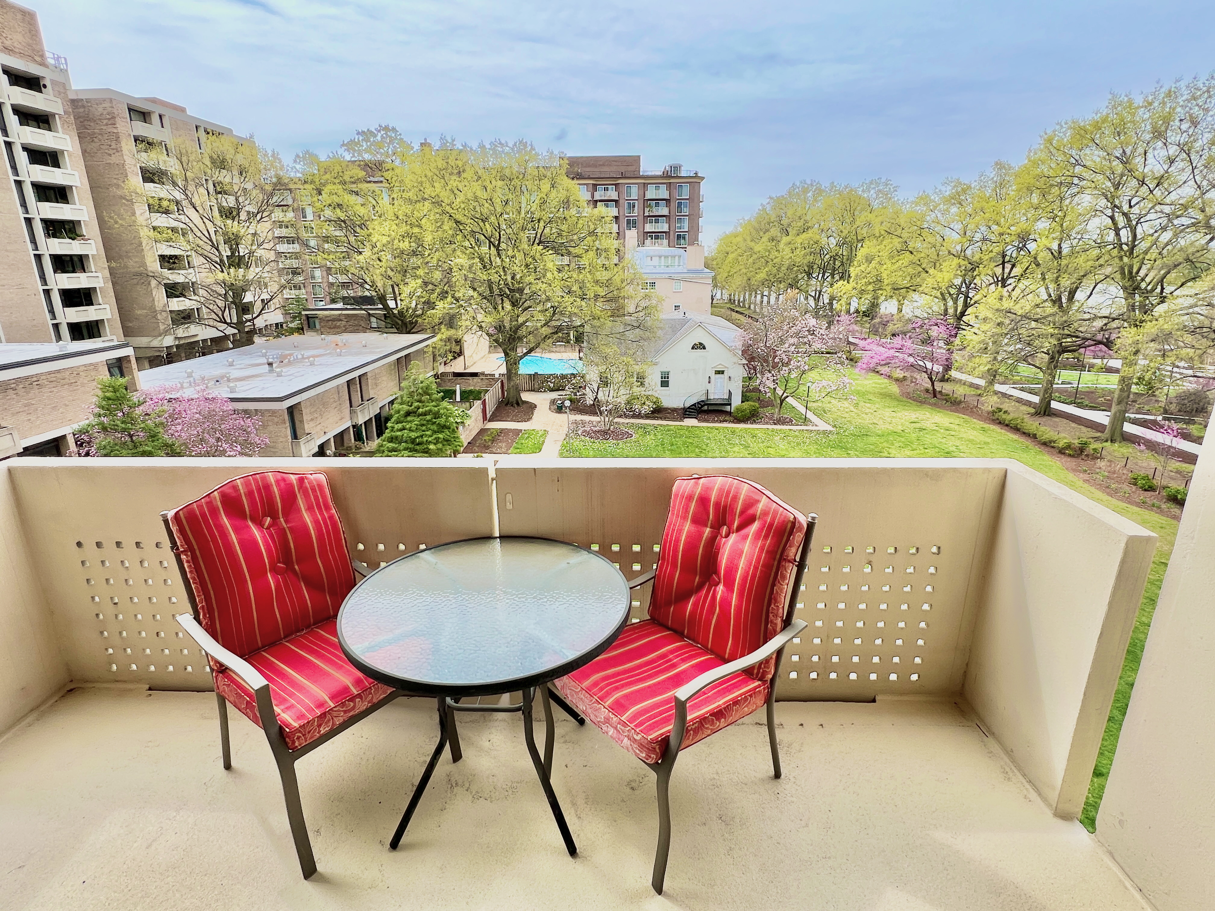 a balcony with table and chairs