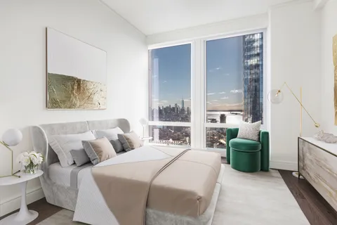a bedroom with a bed and a large window