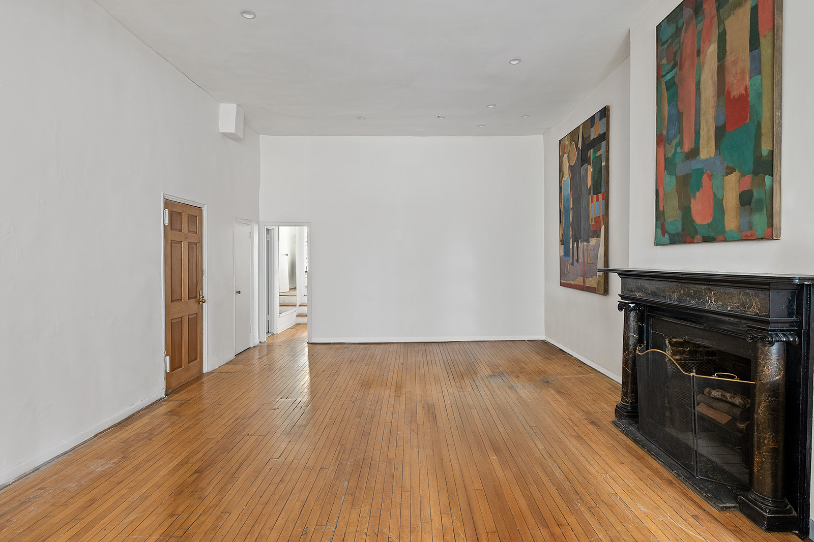 198 6th Avenue Manhattan, NY 10013 - Photo 20 of 45 a view of an empty room with wooden floor and a window
