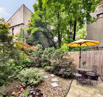 a view of a chair and table in the backyard