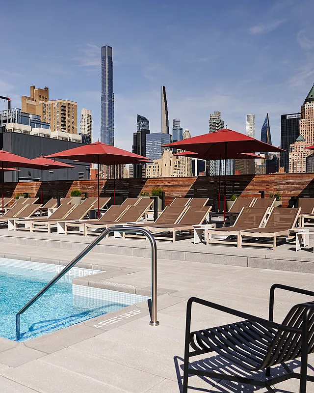 547 West 47th Street, Unit 807 Manhattan, NY 10036 - Photo 10 of 13 a view of a patio with table and chairs under an umbrella