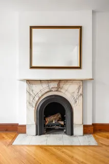 a living room with a fireplace and a large window
