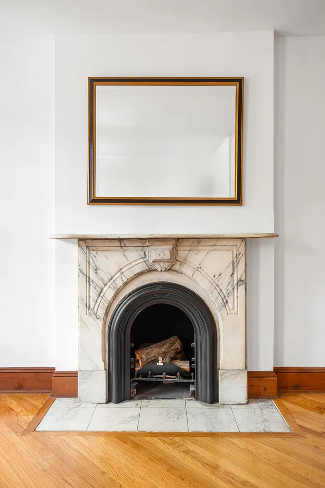 a living room with a fireplace and a large window