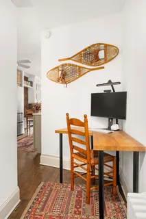 a view of a dining room with furniture and wooden floor