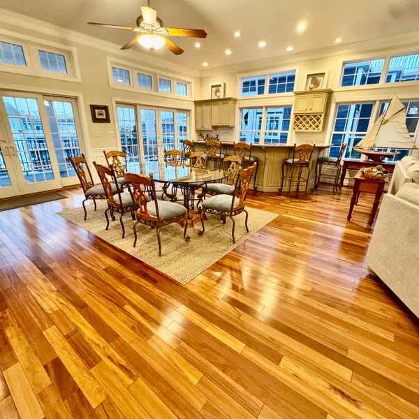 a view of a dining hall with lots of furniture and wooden floors