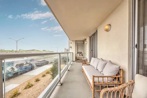 a balcony with furniture and city view