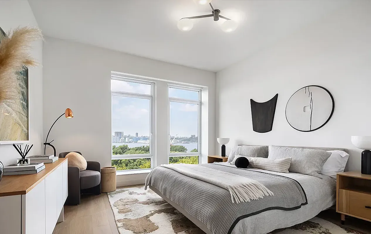 a bedroom with bed and a large window