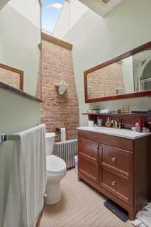 a bathroom with a toilet a sink and a mirror