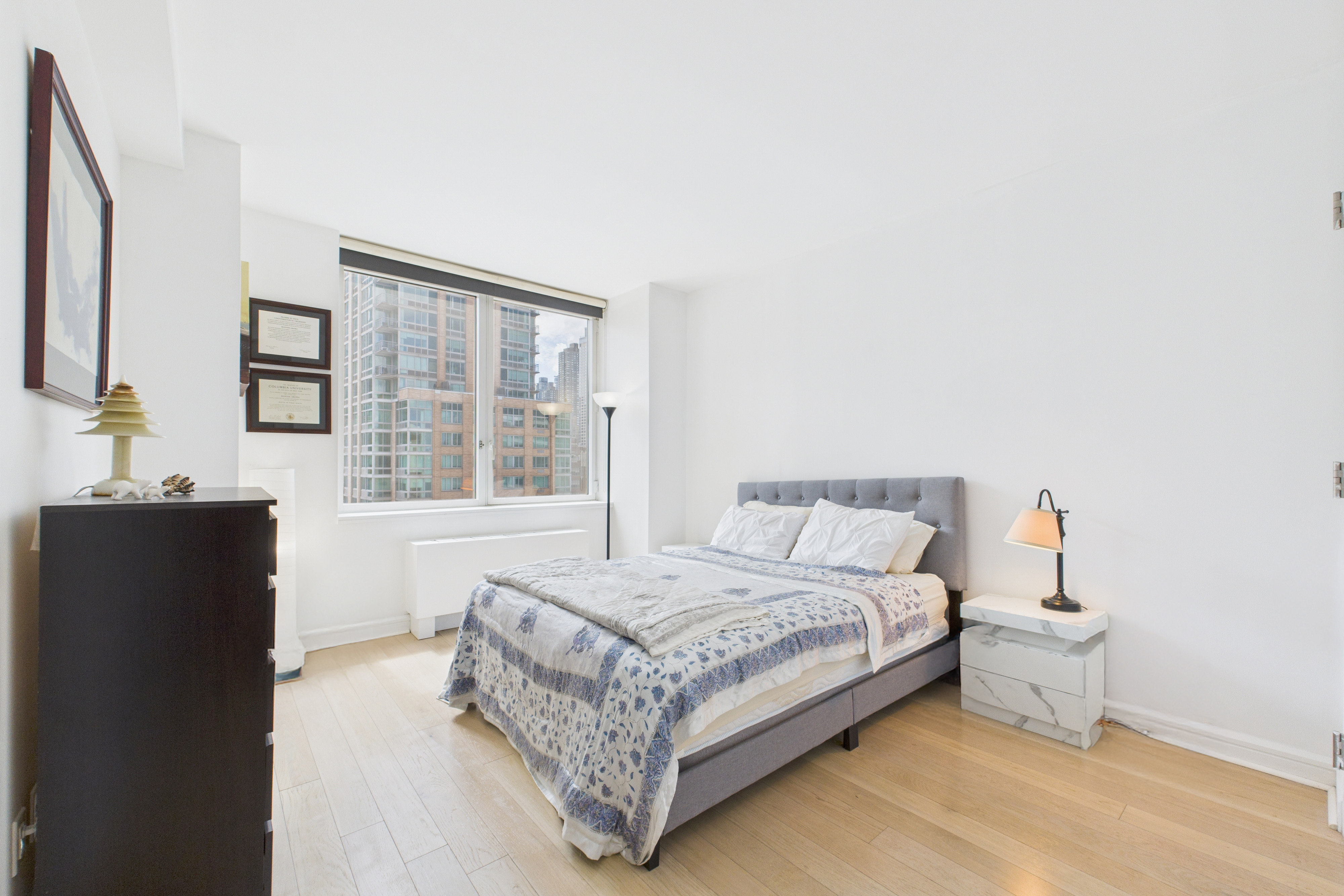 100 Riverside Boulevard, Unit 12B Manhattan, NY 10069 - Photo 7 of 10 a bedroom with a bed and a large window