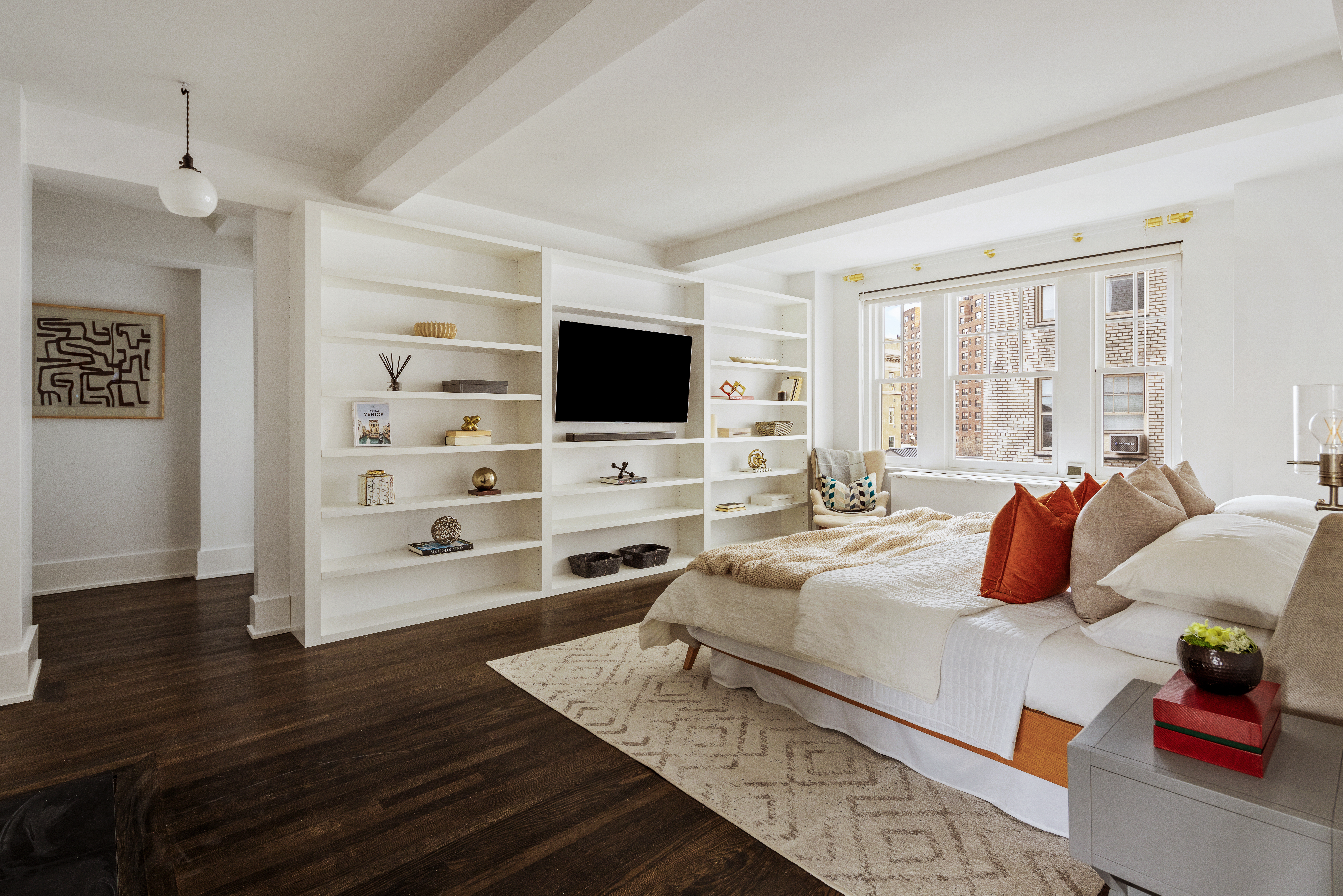 299 West 12th Street, Unit 7BC Manhattan, NY 10014 - Photo 6 of 16 a bedroom with furniture and a flat screen tv