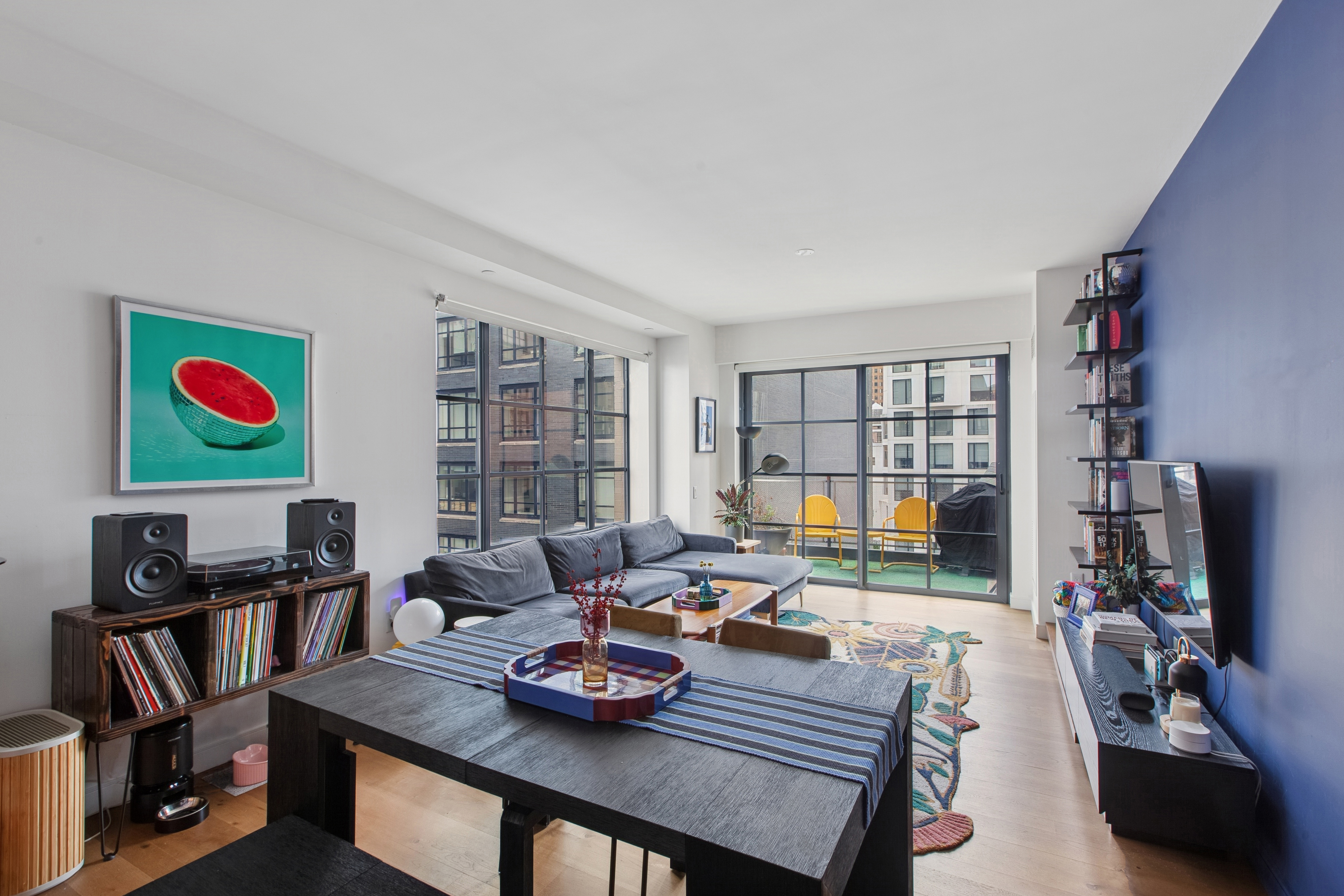 211 Schermerhorn Street, Unit 11A Brooklyn, NY 11201 - Photo 2 of 14 a living room with furniture and a flat screen tv