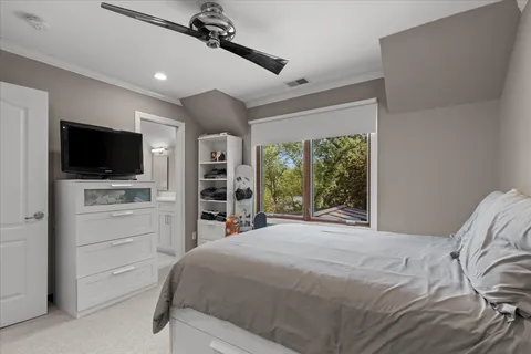 a spacious bedroom with a bed and glass window