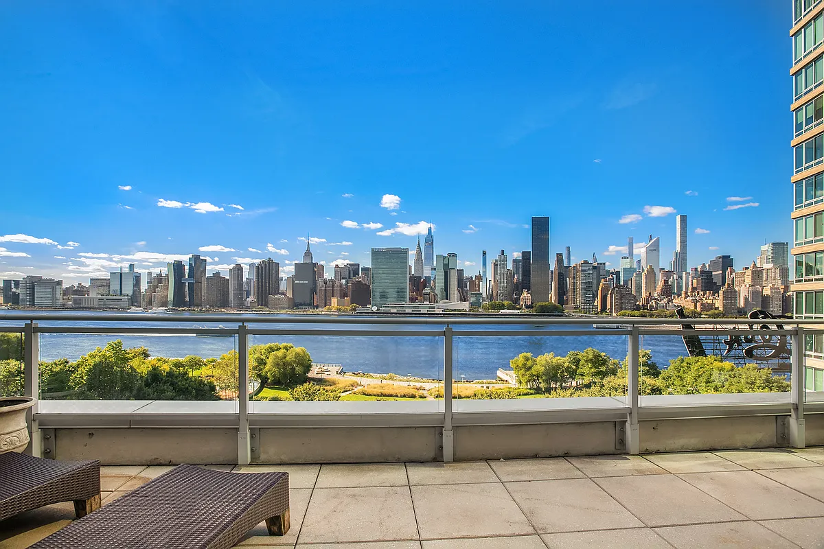 46-30 Center Boulevard, Unit 710 Queens, NY 11109 - Photo 5 of 25 a view of a swimming pool and a lounge chair