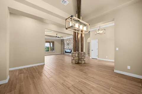 a view of empty room with wooden floor and cabinet