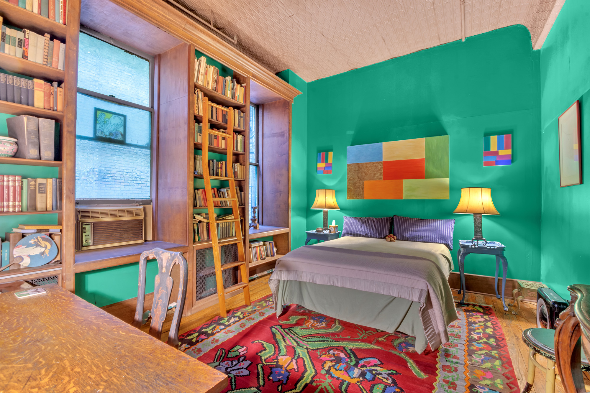 69 Wooster Street, Unit 3 Manhattan, NY 10012 - Photo 12 of 22 a bedroom with a bed and a bookshelf