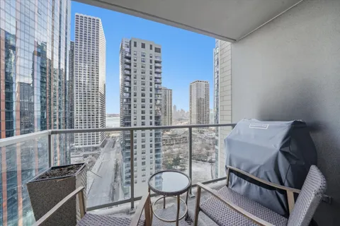 a balcony with chairs and table