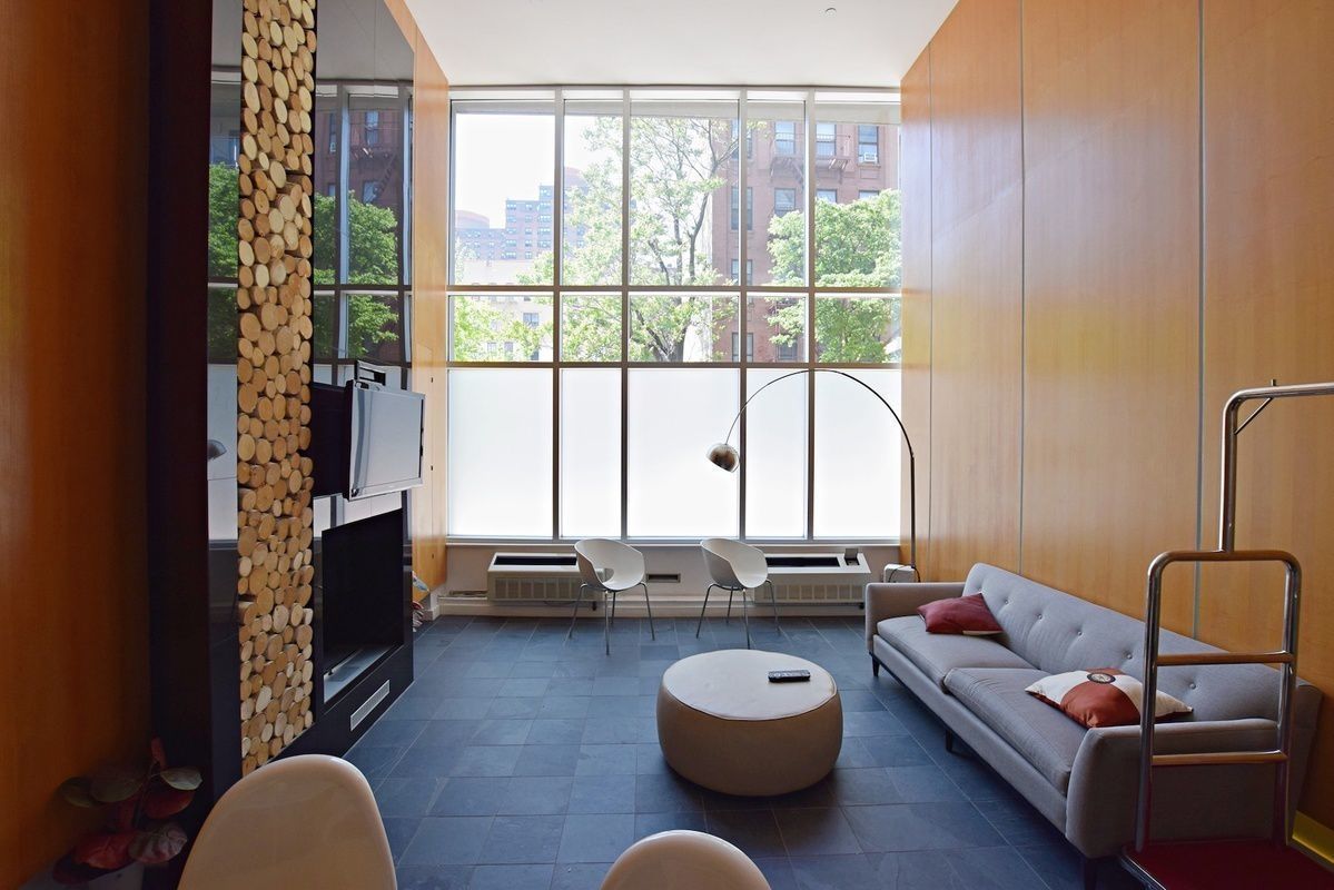 333 East 109th Street, Unit 2A Manhattan, NY 10029 - Photo 9 of 13 a living room with furniture and a large window