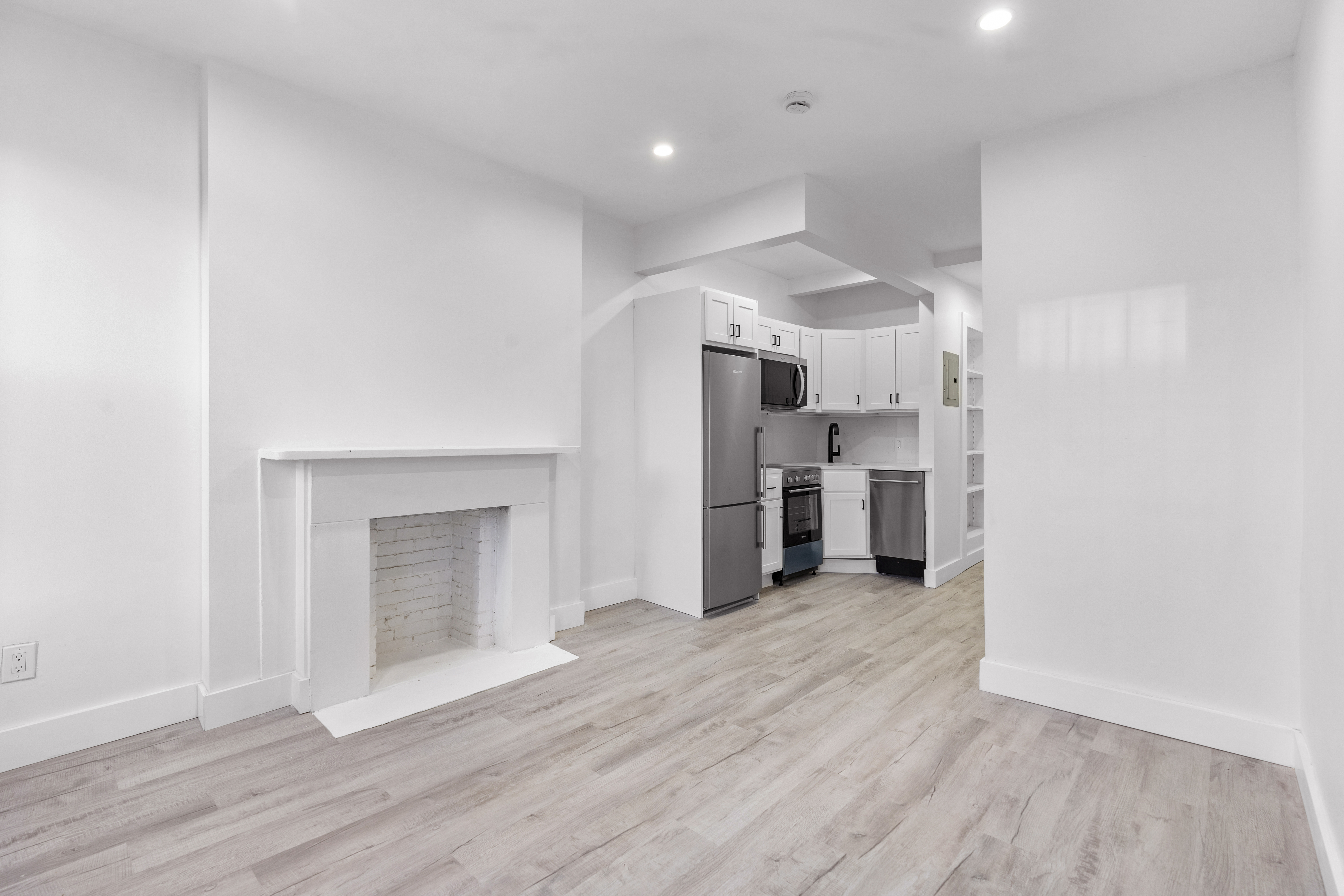714 Greenwich Street, Unit 8 Manhattan, NY 10014 - Photo 2 of 7 a view of a kitchen with a sink and a refrigerator