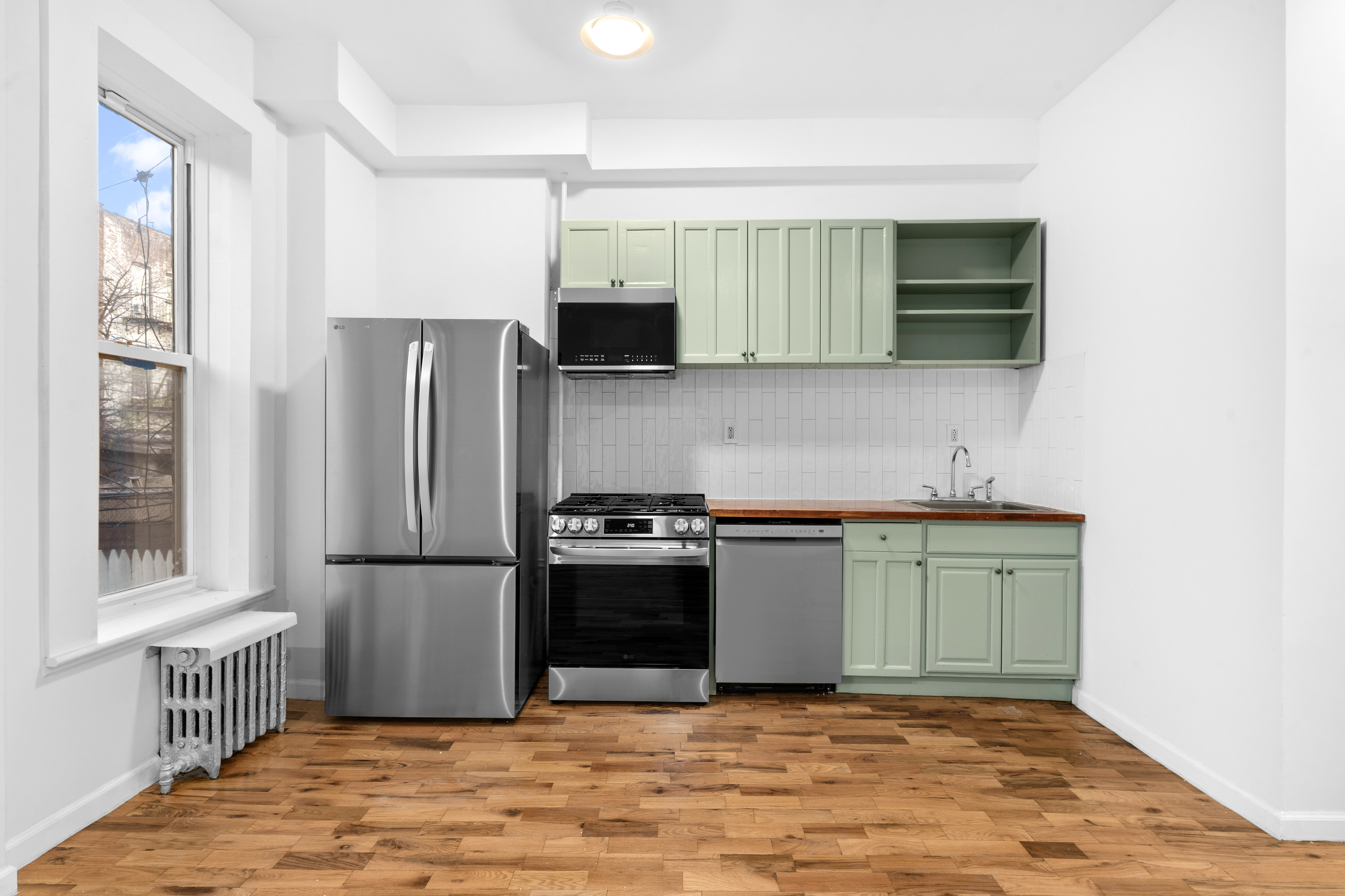 339 East 29th Street Brooklyn, NY 11226 - Photo 10 of 21 a kitchen with a refrigerator and a sink