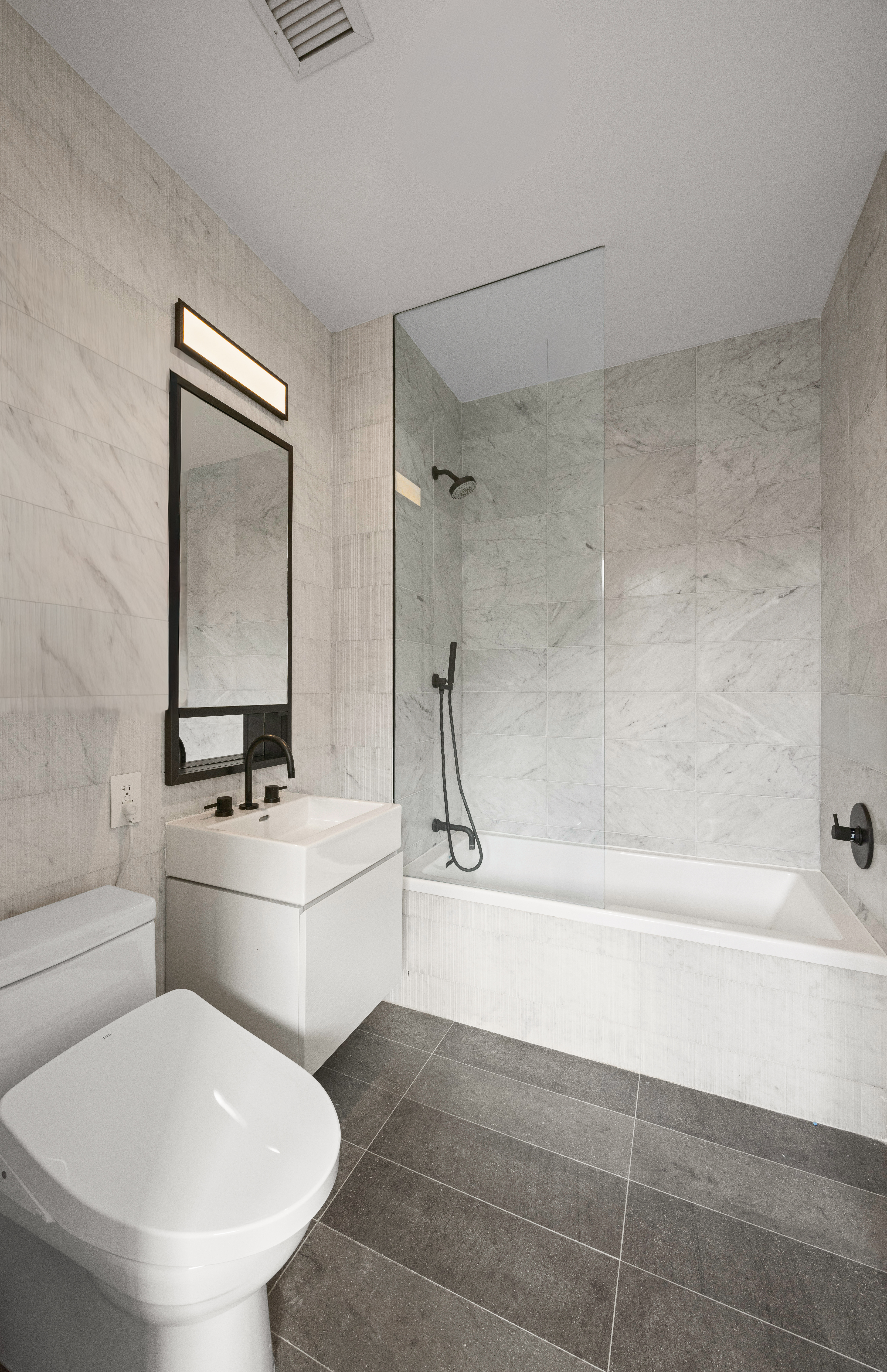 100 Barrow Street, Unit 9A Manhattan, NY 10014 - Photo 11 of 12 a bathroom with a toilet a sink and bathtub