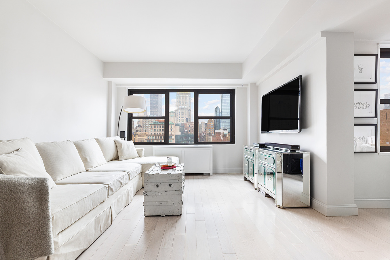 200 East 27th Street, Unit 19C Manhattan, NY 10016 - Photo 3 of 8 a living room with furniture and a flat screen tv
