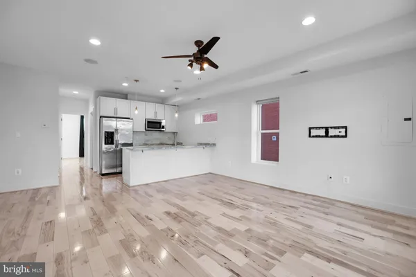 a view of a kitchen with a sink and a refrigerator