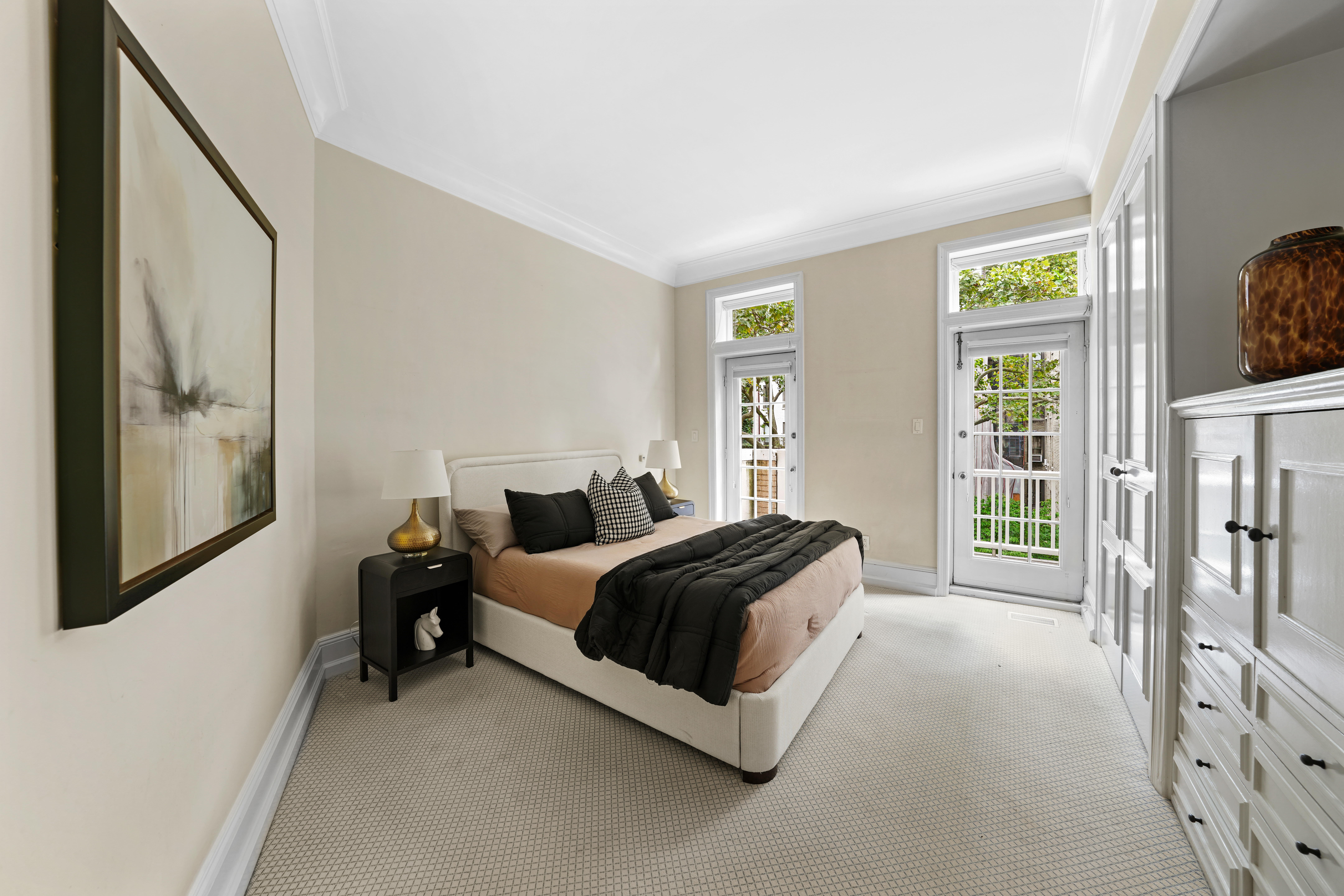 247 East 71st Street Manhattan, NY 10021 - Photo 17 of 31 a bedroom with a bed lamp and a large window