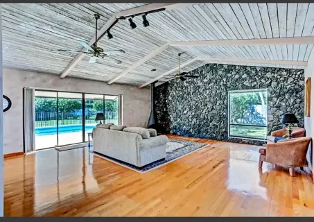 a bedroom with furniture and large window