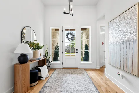 a living room with furniture a chandelier and a window