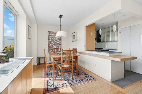 a dining room with a table chairs and a kitchen view