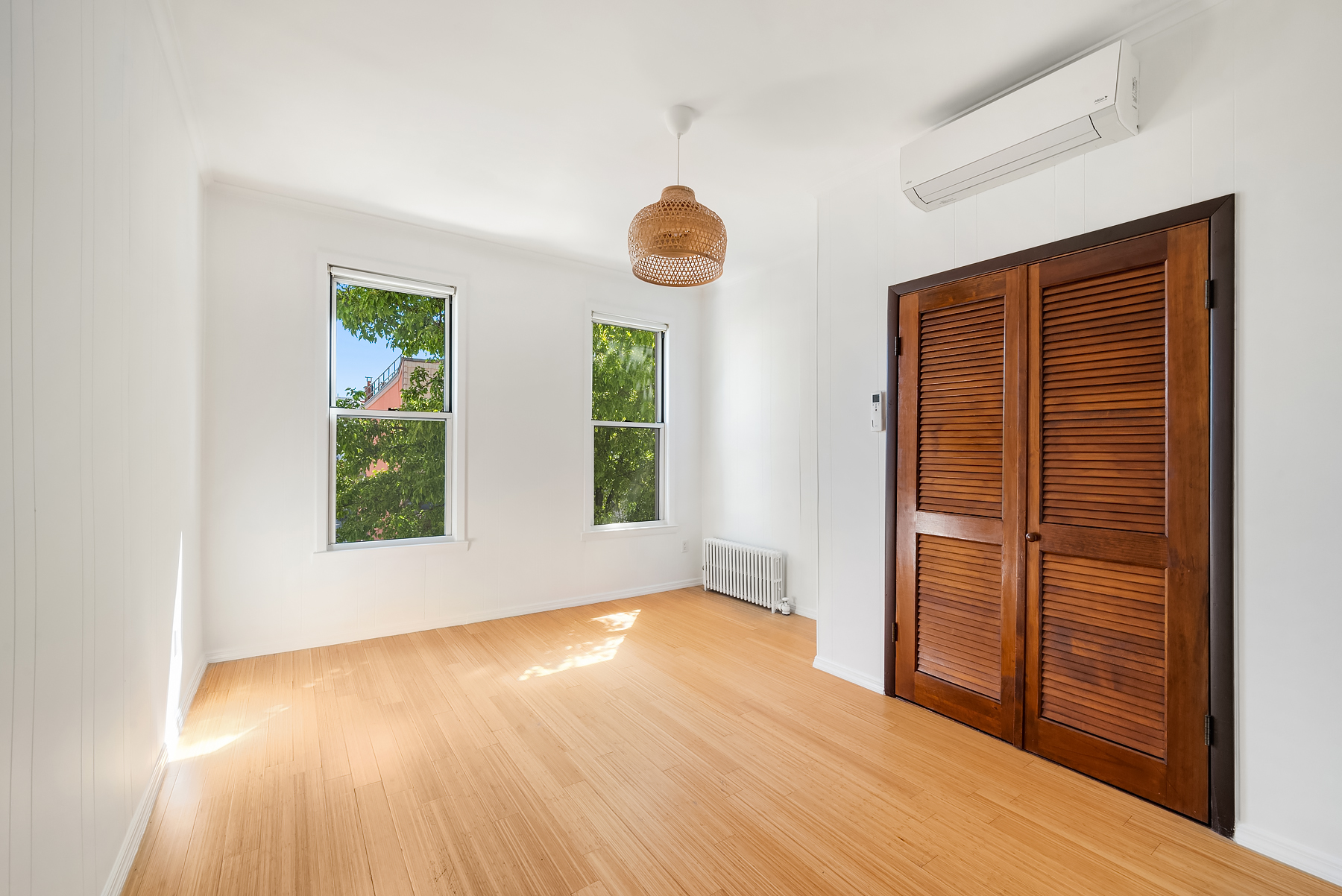 115 Jewel Street, Unit 2L Brooklyn, NY 11222 - Photo 3 of 6 an empty room with wooden floor and windows