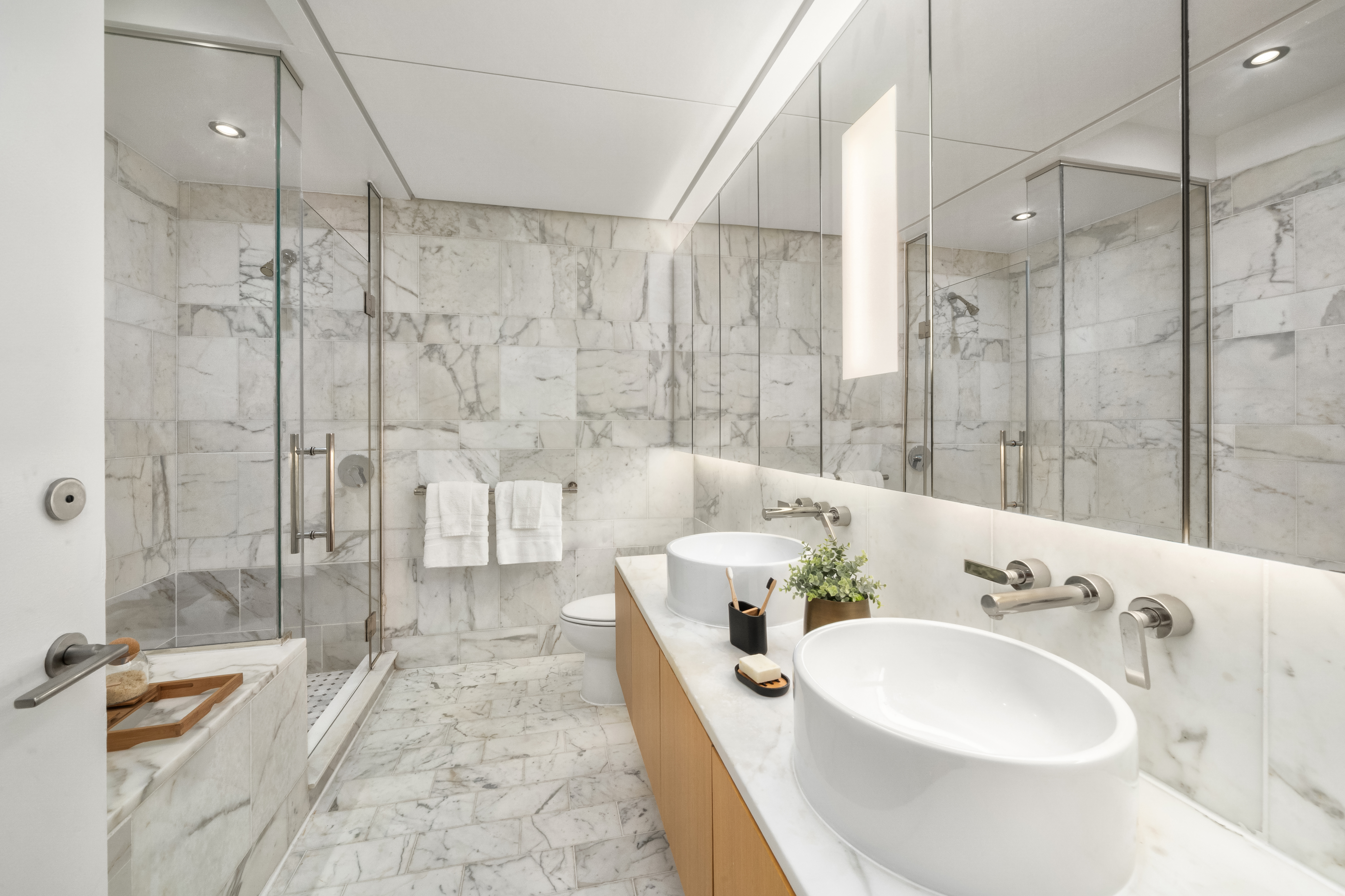 18 West 48th Street, Unit 4F Manhattan, NY 10036 - Photo 9 of 20 a spacious bathroom with a bathtub shower sink and toilet