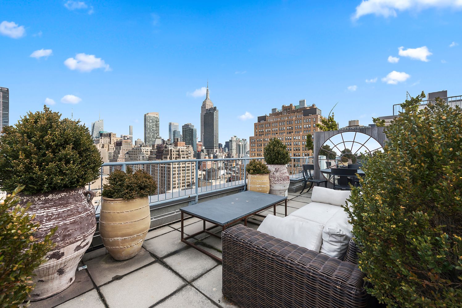 a view of a terrace with chairs and a potted plant
