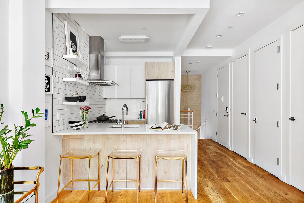 a kitchen with stainless steel appliances granite countertop a sink and cabinets