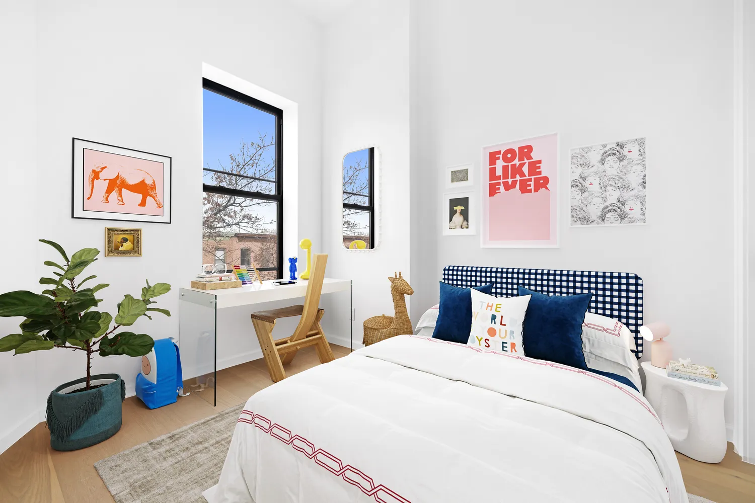 a bedroom with a large bed and a potted plant