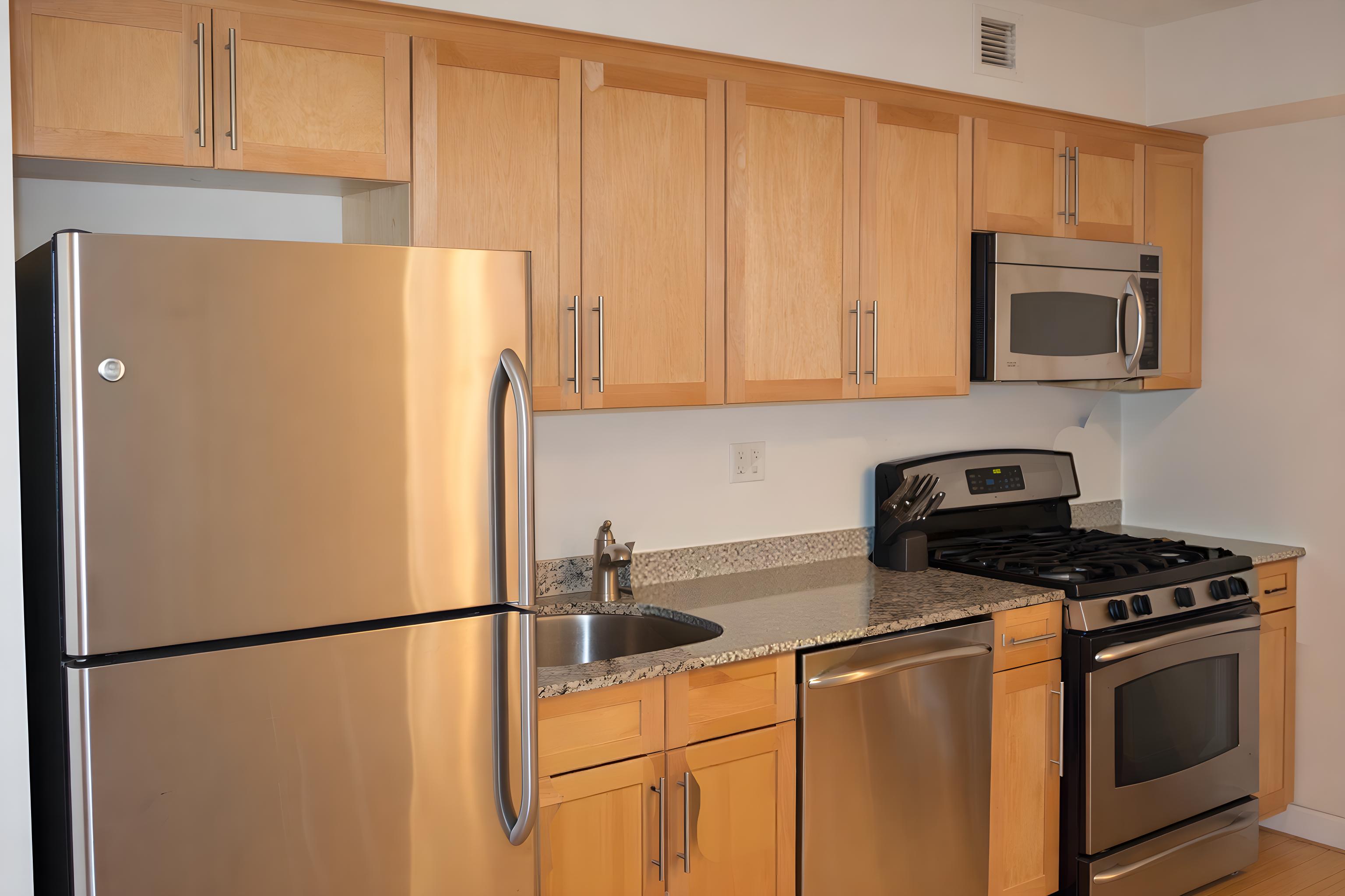 516 West 47th Street, Unit S4D Manhattan, NY 10036 - Photo 2 of 10 a white refrigerator freezer sitting in a kitchen