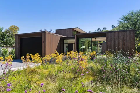 a front view of house with flowers