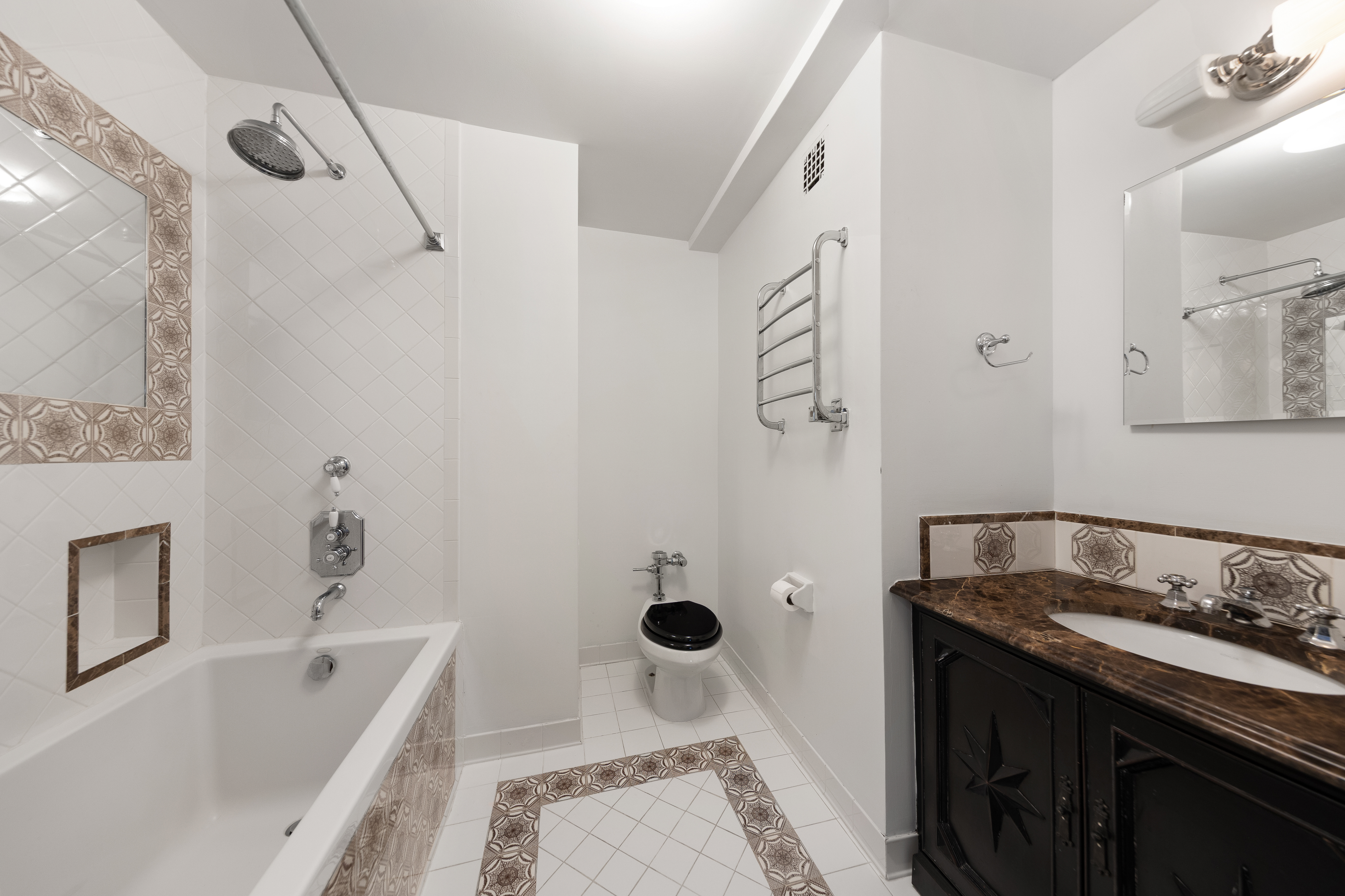 875 5th Avenue, Unit 9GH Manhattan, NY 10065 - Photo 11 of 13 a bathroom with a granite countertop sink a toilet and shower